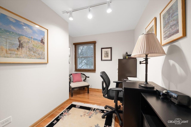 home office featuring light wood-type flooring and rail lighting