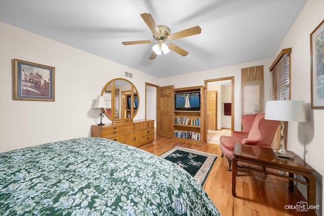 bedroom with hardwood / wood-style flooring and ceiling fan