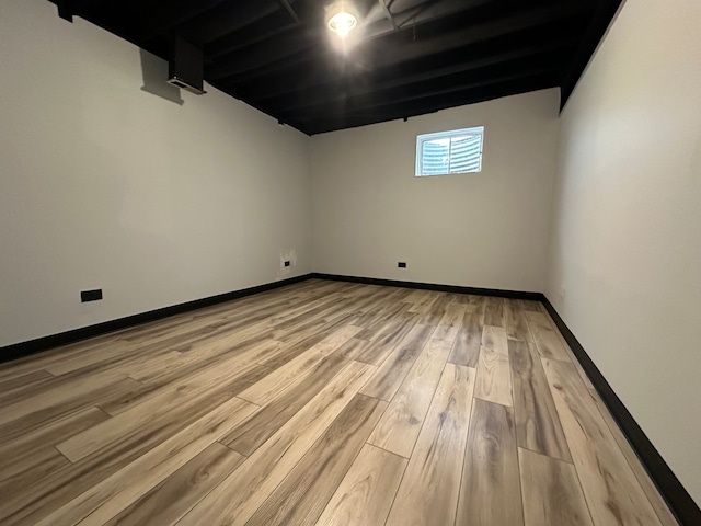 basement with hardwood / wood-style floors