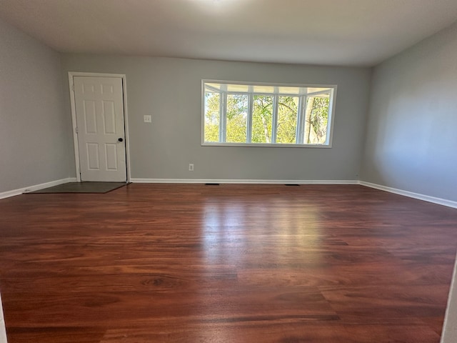 spare room featuring dark hardwood / wood-style flooring