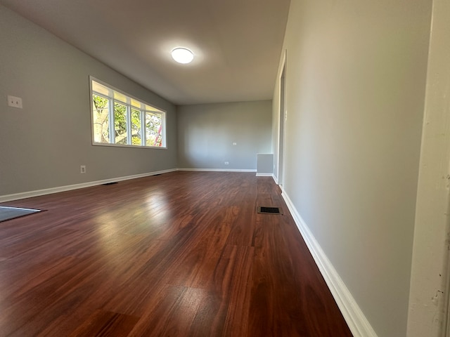 spare room with dark wood-type flooring