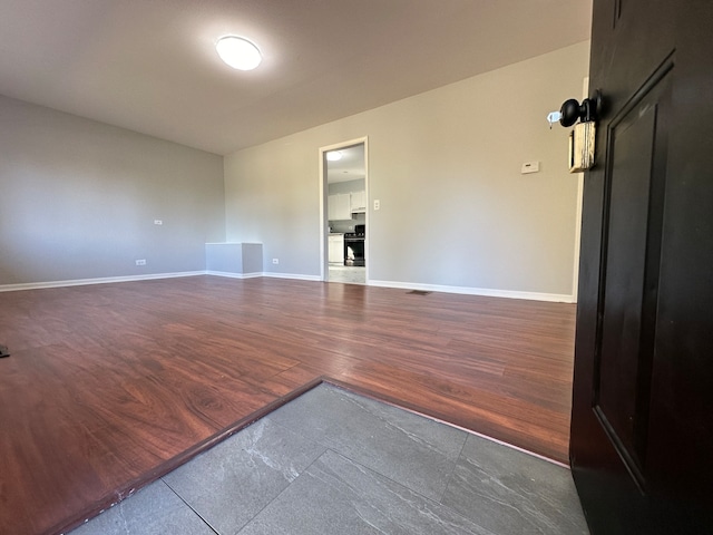 empty room with dark hardwood / wood-style flooring