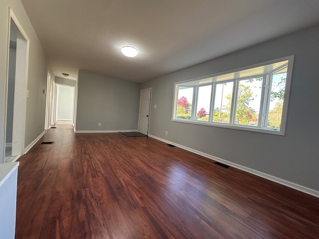 unfurnished room featuring dark hardwood / wood-style floors