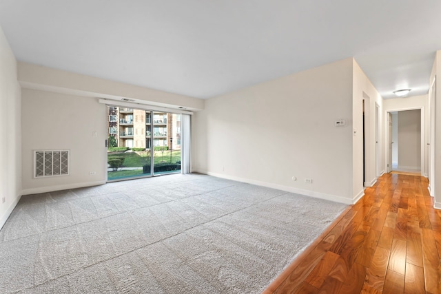 unfurnished room with hardwood / wood-style floors