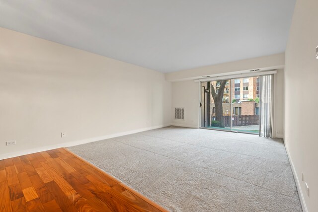 spare room with wood-type flooring