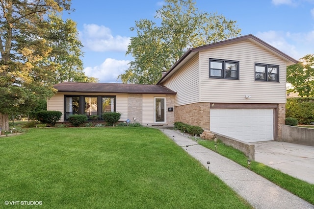 tri-level home with a front yard and a garage