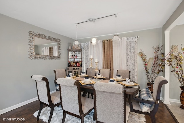 dining space featuring dark wood-type flooring