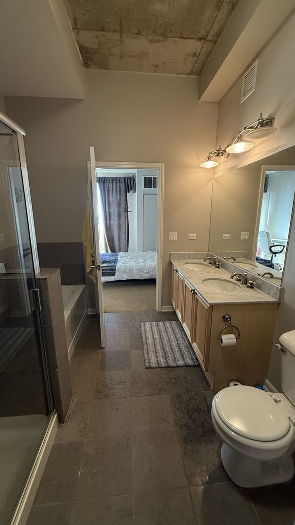 full bathroom with vanity, toilet, and separate shower and tub