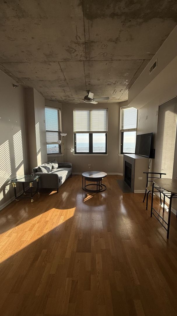 interior space featuring hardwood / wood-style flooring and ceiling fan