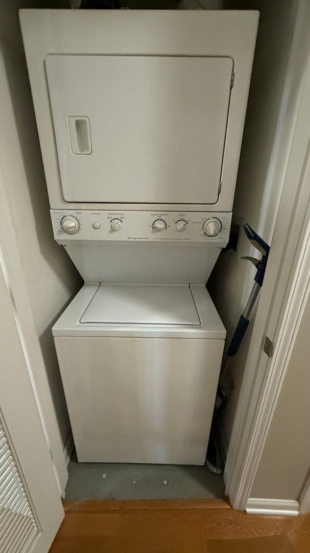 washroom featuring stacked washing maching and dryer