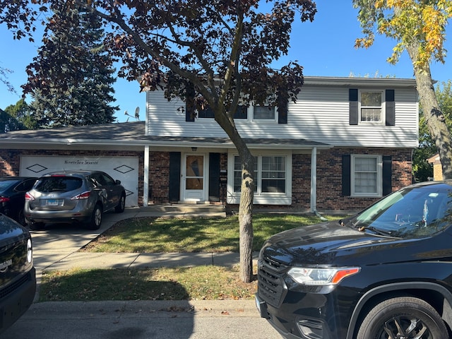 view of front facade with a front yard and a garage