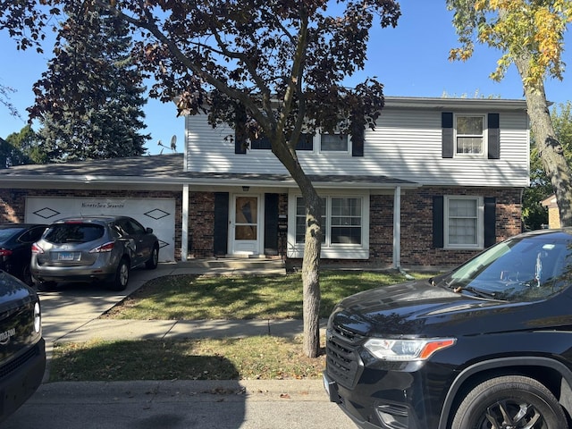 9270 N Courtland Dr, Niles, IL 60714 - traditional-style house featuring brick siding, an attached garage, driveway, and a front yard