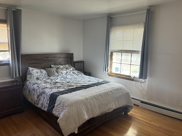 9270 N Courtland Dr, Niles, IL 60714 - bedroom with multiple windows, baseboard heating, and wood finished floors