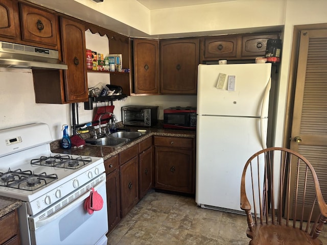9270 N Courtland Dr, Niles, IL 60714 - kitchen with white appliances, under cabinet range hood, a sink, dark countertops, and stone finish flooring