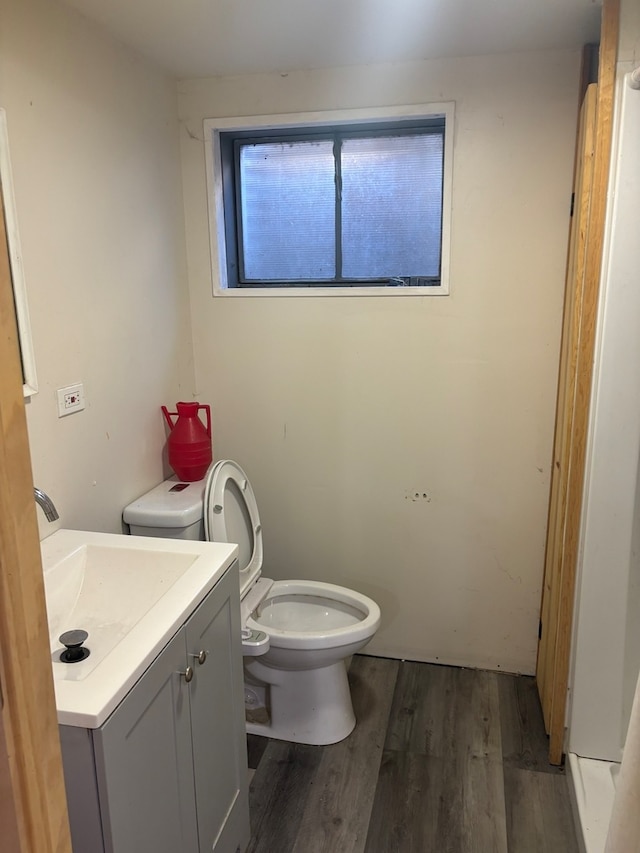 bathroom with vanity, hardwood / wood-style floors, and toilet