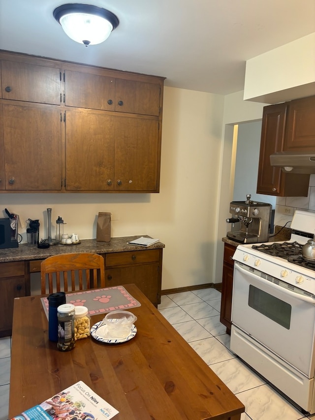 kitchen with white range with gas stovetop