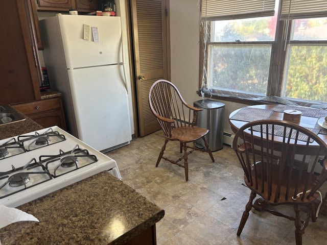 9270 N Courtland Dr, Niles, IL 60714 - kitchen featuring white appliances, dark countertops, stone finish floors, and a sink