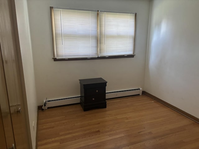 9270 N Courtland Dr, Niles, IL 60714 - unfurnished room with baseboard heating, wood finished floors, and baseboards