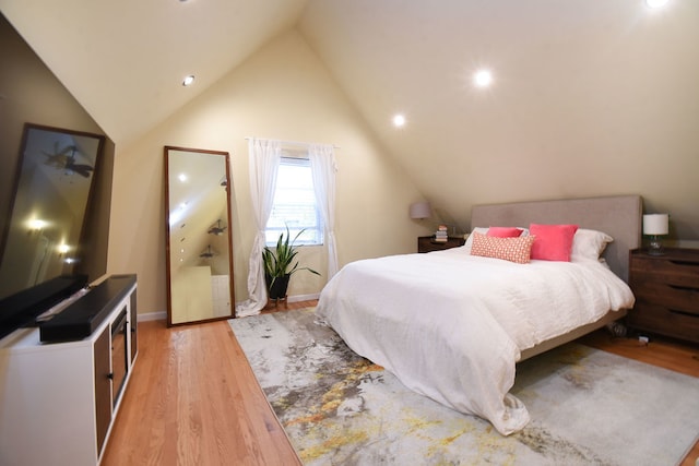 bedroom with lofted ceiling and light hardwood / wood-style flooring