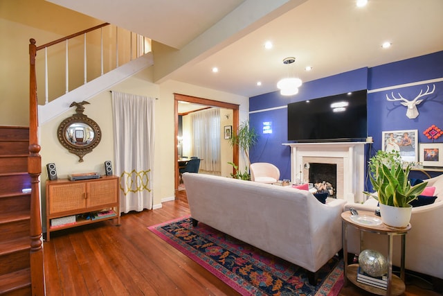 living room with hardwood / wood-style floors and a fireplace