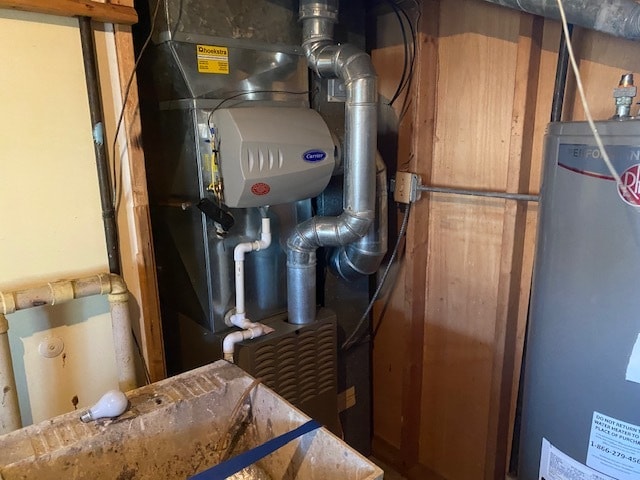 utility room with heating unit and water heater