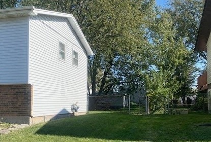 view of property exterior featuring a lawn