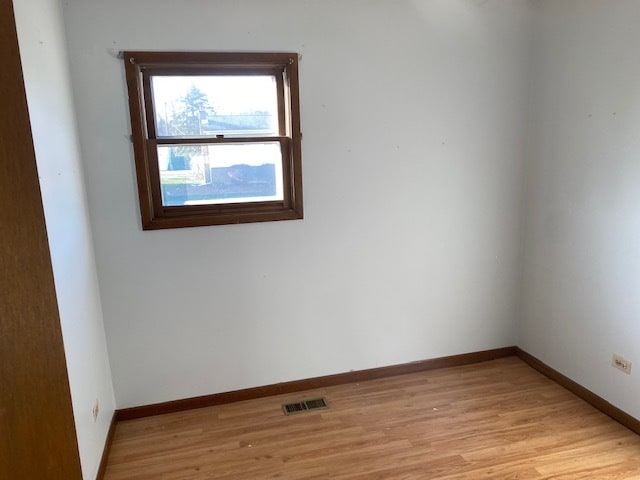 spare room featuring light wood-type flooring