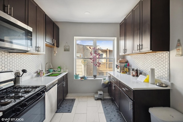 kitchen with tasteful backsplash, sink, stainless steel appliances, and dark brown cabinets