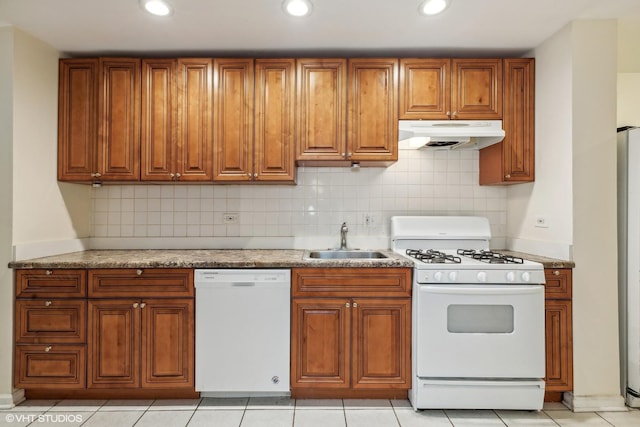 kitchen with backsplash, white appliances, sink, and light tile patterned floors