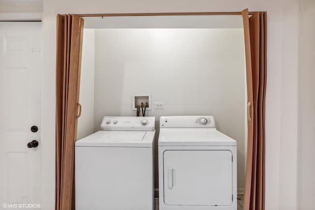 clothes washing area featuring separate washer and dryer