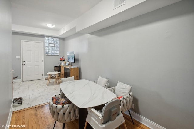 dining space with light wood-type flooring