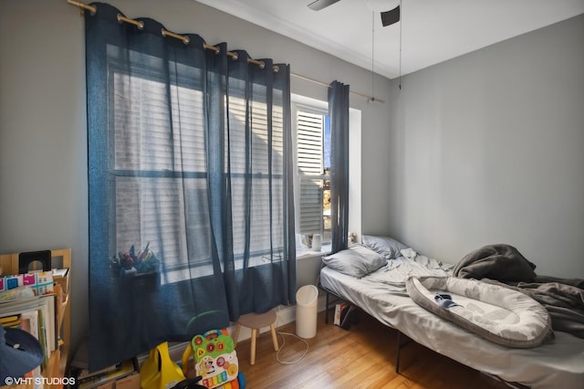 bedroom with wood-type flooring and ceiling fan