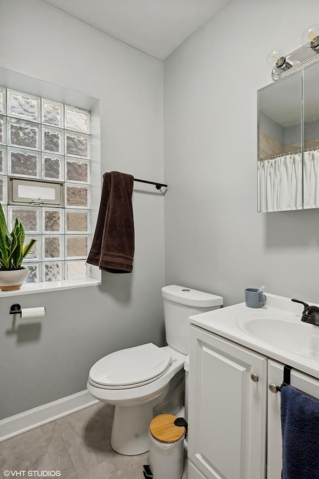 bathroom with tile patterned floors, vanity, and toilet