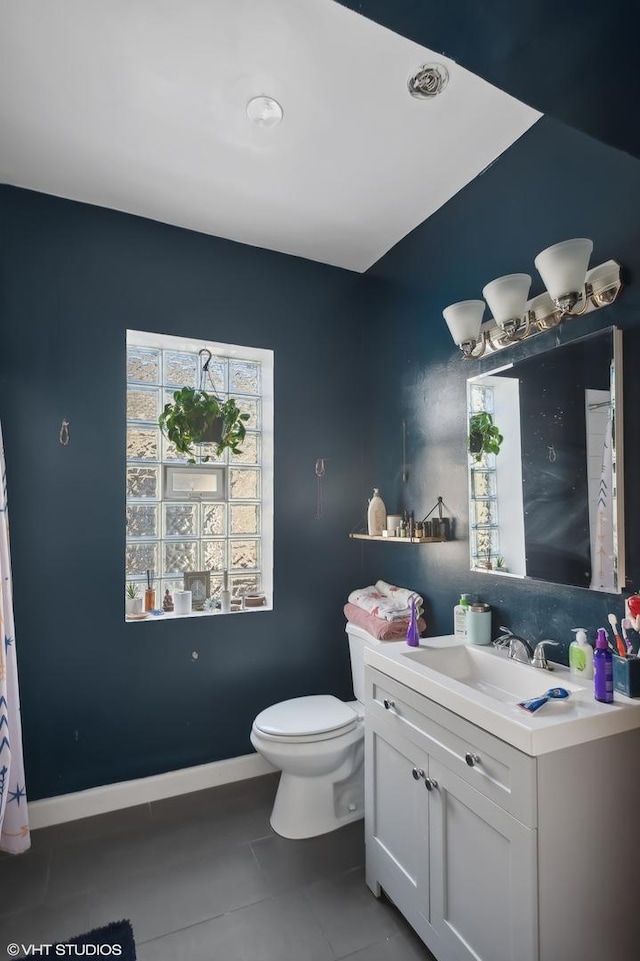 bathroom featuring toilet, vanity, and tile patterned floors