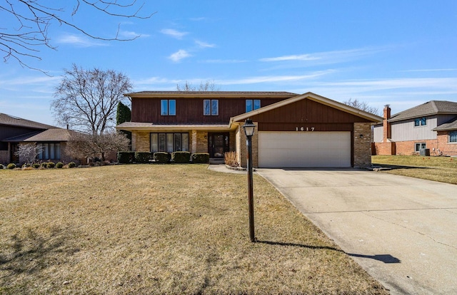 1617 Cimarron Dr, New Lenox, IL 60451 - view of front of house featuring an attached garage, concrete driveway, brick siding, and a front lawn