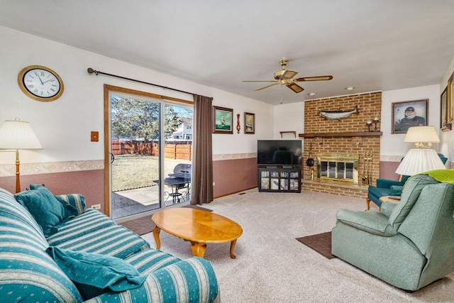 1617 Cimarron Dr, New Lenox, IL 60451 - living area with carpet, a ceiling fan, a fireplace, and a wainscoted wall