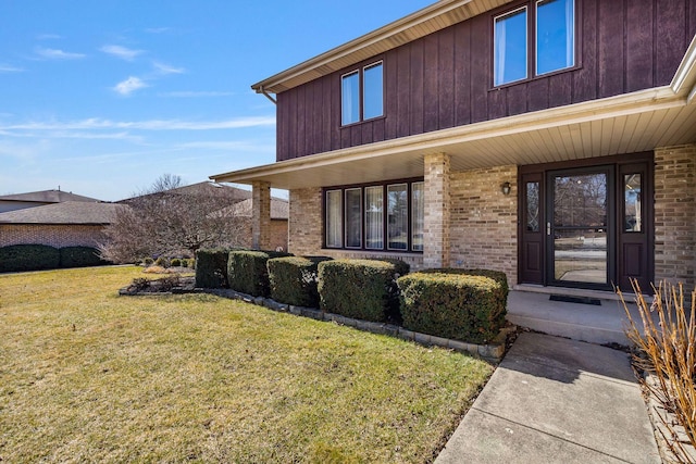 1617 Cimarron Dr, New Lenox, IL 60451 - property entrance featuring a lawn, brick siding, and a porch