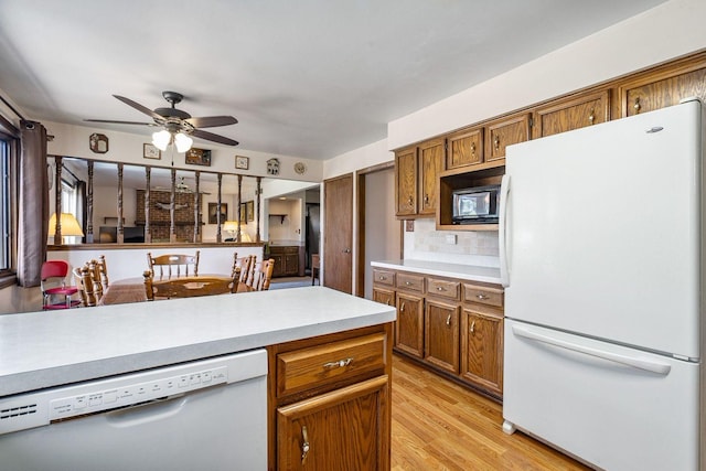 1617 Cimarron Dr, New Lenox, IL 60451 - kitchen featuring white appliances, brown cabinets, ceiling fan, and light countertops