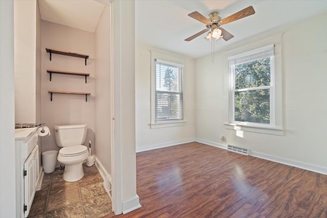 bathroom with vanity, wood-type flooring, toilet, and ceiling fan