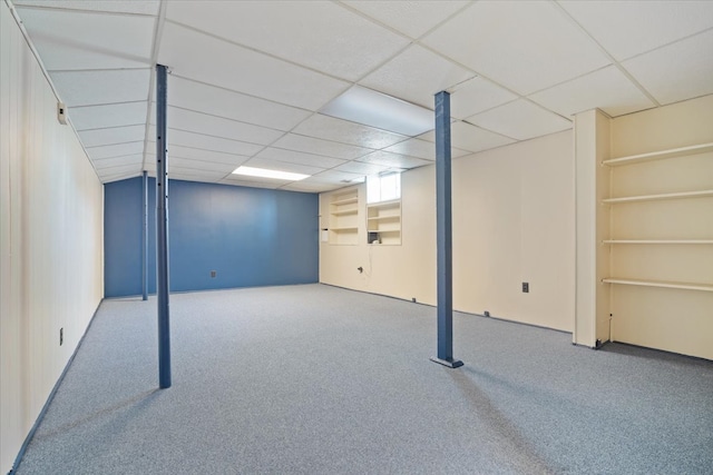 basement with carpet and a drop ceiling