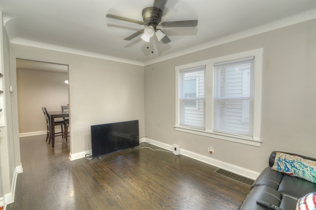 sitting room featuring ceiling fan, crown molding, and dark hardwood / wood-style flooring