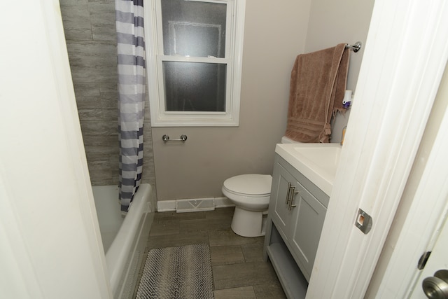 full bathroom featuring vanity, shower / tub combo with curtain, toilet, and hardwood / wood-style flooring