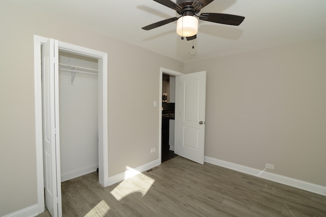 unfurnished bedroom with wood-type flooring, a closet, and ceiling fan