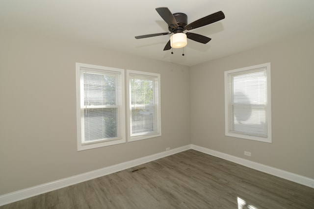 unfurnished room with ceiling fan and dark hardwood / wood-style floors