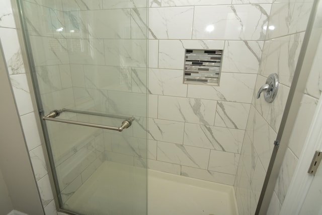 bathroom with a shower with shower door