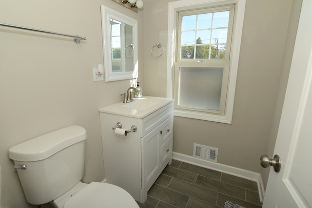 bathroom featuring toilet and vanity