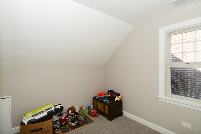 recreation room with carpet flooring and vaulted ceiling