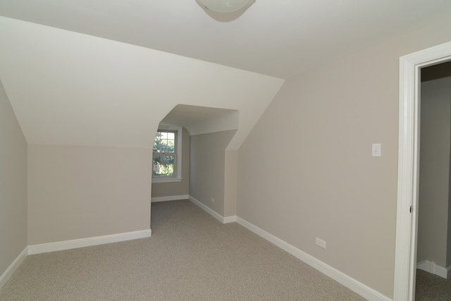 bonus room featuring light carpet and lofted ceiling