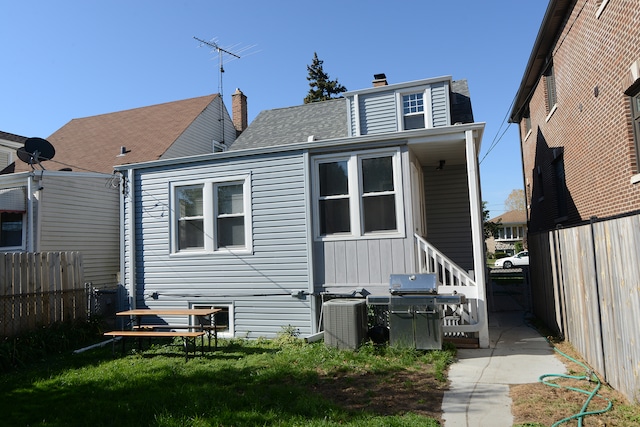 rear view of house with central air condition unit