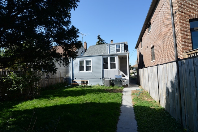 rear view of property with a lawn